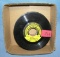 Box of vintage 45 RPM records