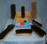 Box full of vintage shoe shine brushes