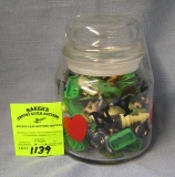 Glass jar full of vintage toys and collectibles