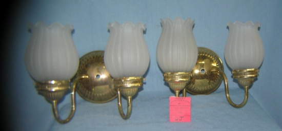 Pair of brass wall sconces with frosted glass shades