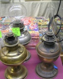 Group of four antique brass and copper oil lamps