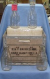 Group of antique milk bottles with crate