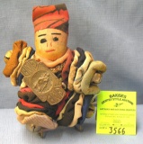 Antique doll with bells and decorations