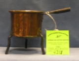Antique copper kettle with cast iron legs and handle