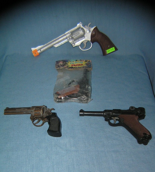 Group of 4 vintage toy plastic cap guns and more.