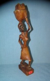 Hand carved African woman carrying a basket