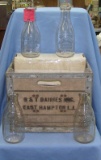 Group of antique milk bottles with crate