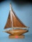 Hand carved wood sail boat on stand