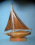 Hand carved wood sail boat on stand