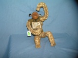 Vintage monkey toy made of wood, leather and rope