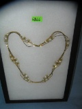 Gold tone and pearl multi strand necklace