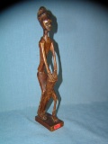 Hand carved African man playing the bongoes