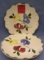 Group of four floral decorated serving plates