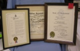 Three framed awards and proclamations