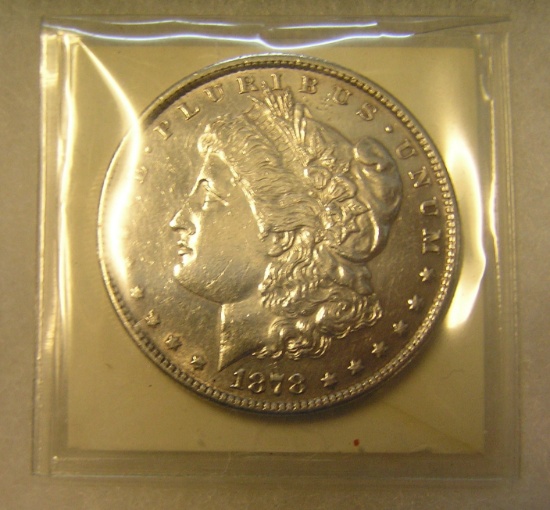 1878S Morgan silver dollar in AU condition
