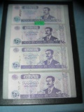 Group of Iraqui currency featuring Saddam Hussien