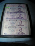 Group of Iraqui currency featuring Saddam Hussien