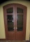 Pair of elegant 8 pane curved top hard wood doors