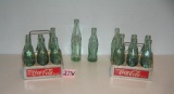 Collection of Coca Cola bottles and 2 early carriers