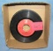Box of vintage 45 RPM records