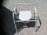 Brand new folding commode with paper work
