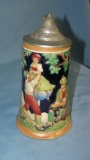 Vintage German beer stein features festive group of 3