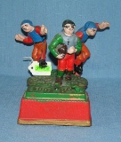 Hand painted cast iron football mechanical bank