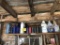 ASSORTED LUBRICANTS, SKIS & MISCELLANEOUS ON BACK WALL