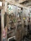 SIGN, PAINT ROLLERS, LP REGULATORS, VACUUMS, WICKER BASKETS & MISC. ON WALL