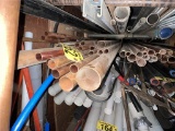 LOT OF COPPER PIPE IN RACK AND ALONG WALL