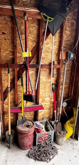 CONTENTS IN CORNER: LONG HANDLED TOOLS, HITCH, AXE, TIRE CHAINS