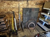 MISC. LOT ALONG BACK WALL: LONG HANDLED TOOLS, STONE HEARTH PAD, MISC. CONDUIT