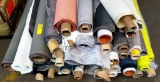 PALLET OF OVER 50 MISC, PARTIAL ROLLS OF UPHOLSTERY FABRIC