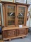 Antique cupboard with glass doors and carved doors