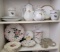 One shelf of china and second shelf of various plates and more