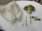Two masks, one post and approximately 26 white feathers
