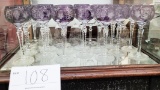 Eight crystal water goblets (or flutes) and 14 purple crystal wine glasses