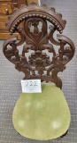 Antique dark wood hand carved chair, green velvet cushion