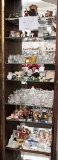 Seven shelves of small knick knacks, glass items, souvenirs