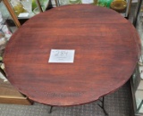 Round dark red wood table with black metal legs  27