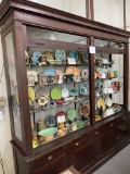 Dark wood display case with five drawers, glass doors move up