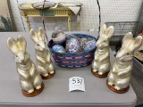 Four glass rabbits, basket of eggs