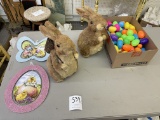 Two brown rabbits, two Easter wall hangings, box of eggs