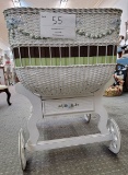 White wicker bassinet w/pastel floral trim, two drawers