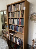 Tall oak bookcase with books, seven shelves
