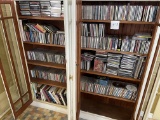 All CDs and books in the white cabinet, approximately 640 CDs