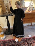 Statue of priest in black velvet robe  40