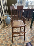 Antique high chair with caned seat 39