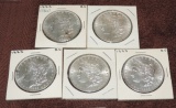 (5) Au And Bu Morgan Silver Dollars