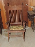 Antique pressed back rocking chair with leather seat